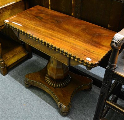 Lot 1296 - A William IV mahogany fold over tea table, the baluster support on shaped base