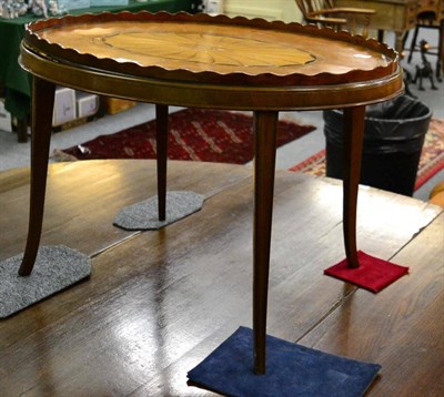 Lot 1299 - A mahogany rosewood crossbanded tea tray, adapted as a coffee table with a wavy shaped gallery,...