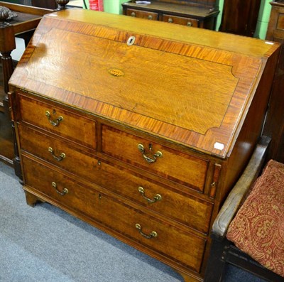 Lot 1304 - An early 20th century cross banded oak bureau