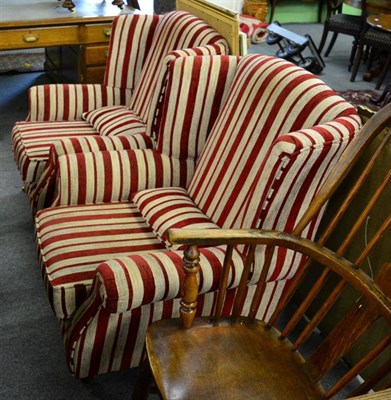 Lot 1329 - A pair of modern red and cream striped wing armchairs