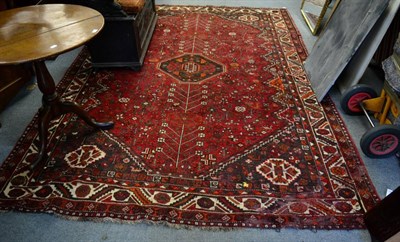 Lot 1330 - Kashgai Carpet, south west Iran, the claret field of tribal motifs around an octagon framed by...