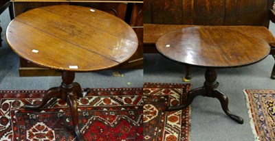 Lot 1331 - ^ Two George III oak tilt top tripod tables