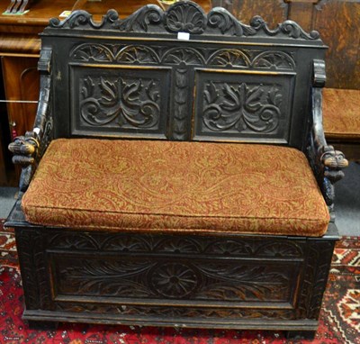 Lot 1332 - ^ A carved oak two panelled box settle