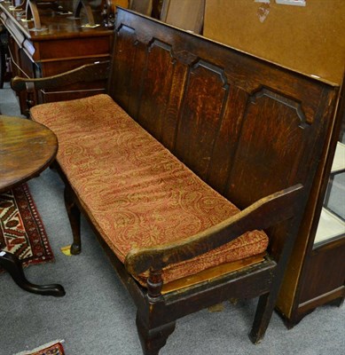 Lot 1333 - ^ A 19th century oak four panelled settle