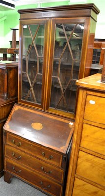 Lot 1347 - A cross banded and inlaid mahogany bureau bookcase with glazed upper section