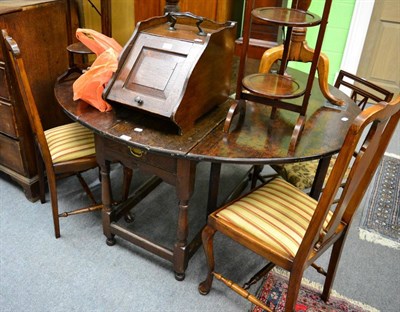 Lot 1357 - An oak oval drop leaf gateleg dining table