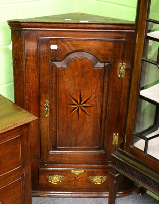 Lot 1376 - A George III oak and inlaid wall hanging corner cupboard, integral moulded cornice above single...