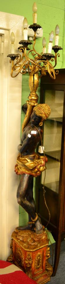 Lot 1380 - A reproduction blackamoor six light candelabra