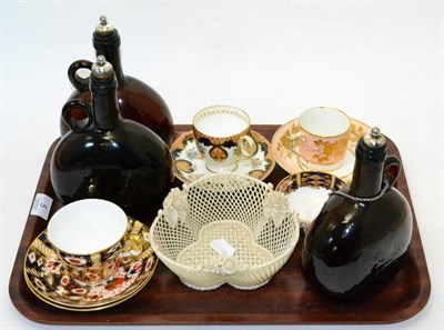 Lot 5 - Early Belleek trefoil basket, three Victorian amber glass carafes and four cabinet cups and saucers