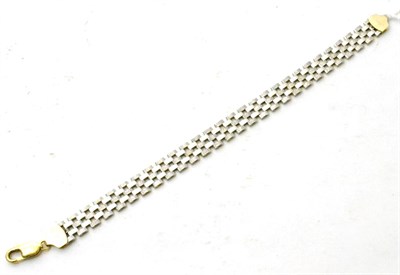Lot 91 - A reversible yellow and white metal link bracelet, stamped '14K'