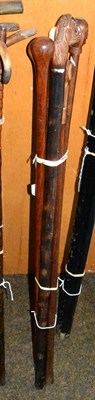 Lot 152 - Six walking canes, three with carved grips