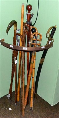 Lot 154 - Fourteen walking sticks, stick seats and a reproduction sword
