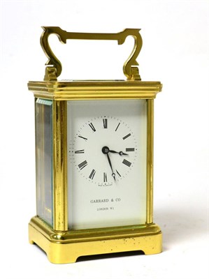 Lot 180 - A Garrad & Co carriage clock with presentation plaque to door