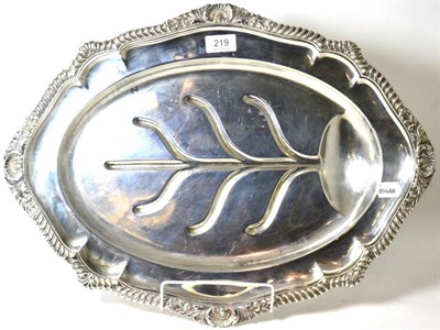 Lot 219 - A plated meat dish on four scroll legs