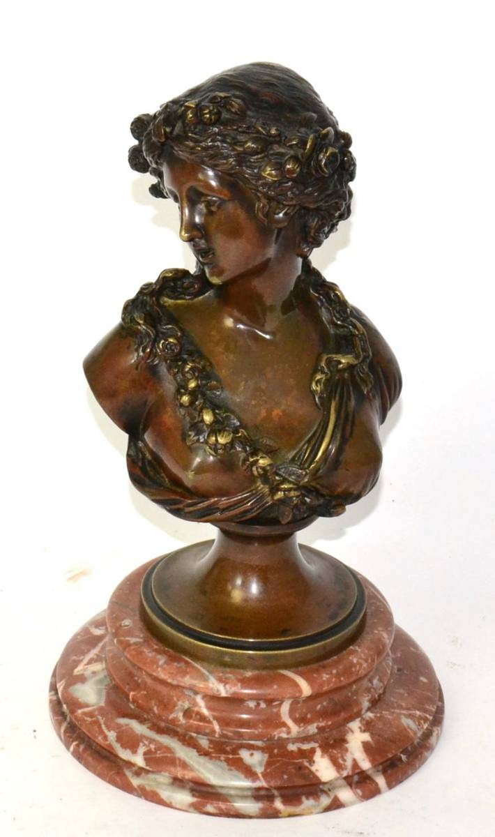 Lot 237 - A bronze bust of a classical maiden on a marble plinth