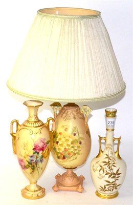 Lot 239 - Two Royal Worcester blush ivory twin handled vases and a blush ivory lamp and shade