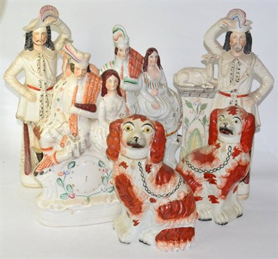 Lot 246 - A pair of Staffordshire king Charles spaniels and two pairs of Staffordshire Scottish figural...