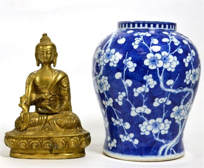 Lot 15 - A Chinese blue and white jar with prunus decoration and a cast metal Buddha