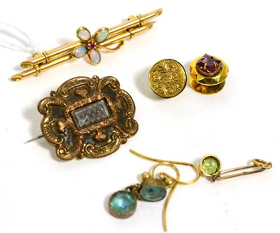 Lot 77 - An opal and ruby bar brooch, a pair of garnet set dress buttons, a mourning brooch, a peridot...