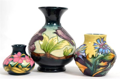 Lot 115 - Moorcroft pottery: a group of three vases, Wine Magnolia designed by Walter Moorcroft, 14cm...