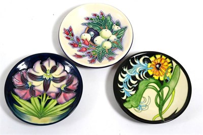 Lot 144 - Moorcroft pottery; three coasters, Plume by Emma Bossons, Snowberry by Nicola Slaney and Porporo by