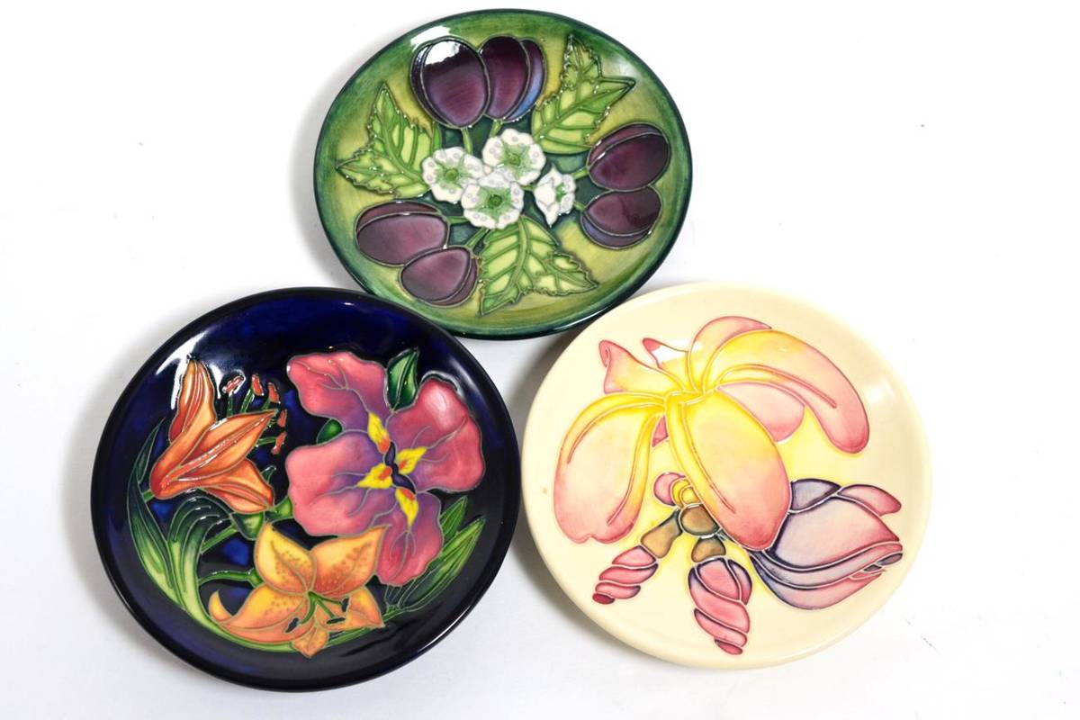 Lot 152 - Moorcroft pottery: a group of three coasters, Damson trainee, designed by Debbie Hancock,...