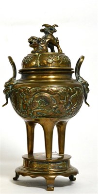 Lot 169 - A Japanese bronze koro, raised on three tall feet, with twin handles and a lift off cover