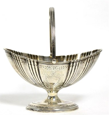 Lot 182 - A Victorian silver swing handled sugar basket of George III design