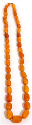 Lot 209 - A graduated amber bead necklace, 102cm long