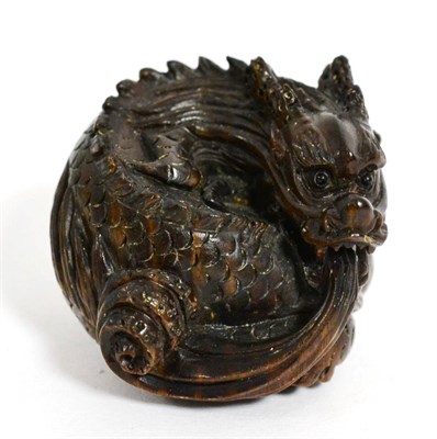 Lot 216 - A Japanese carved wood netsuke modelled as a dragon, signed