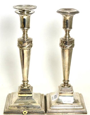 Lot 400 - A pair of silver candlesticks, the bases drilled for electricity