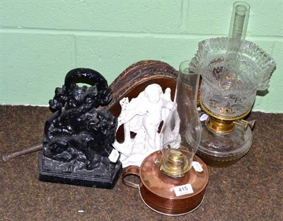 Lot 415 - Two Victorian cast iron doorstops and two oil lamps of similar dates and a pair of bellows