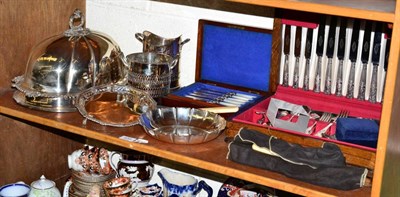 Lot 420 - A shelf of silver plate including an old Sheffield plate meat dome, a canteen, a dish, other...