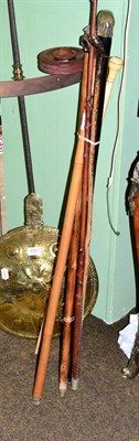 Lot 424 - A group of assorted walking canes three with novelty animal head handles, one bone example with...