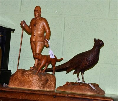 Lot 475 - K Bateson, a carving of a pheasant on a naturalistic base, dated 1978 together with another carving