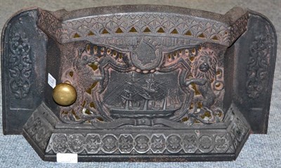 Lot 1037 - A cast iron fire grate, circa 1887, cast and pierced with a ship flanked by the royal...