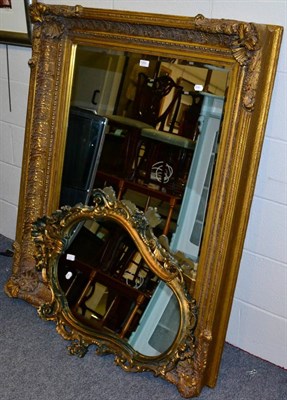 Lot 1093 - A large rectangular gilt composition wall mirror and another rococo style example