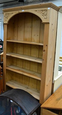 Lot 1104 - A tall pine open bookshelf with acorn carved detail