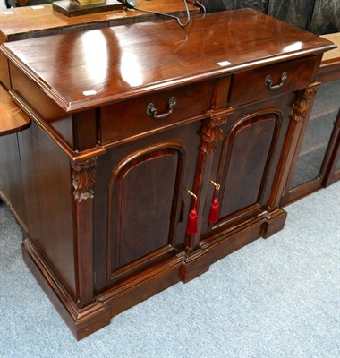 Lot 1118 - A mahogany side cupboard with two drawers over a pair of cupboard doors