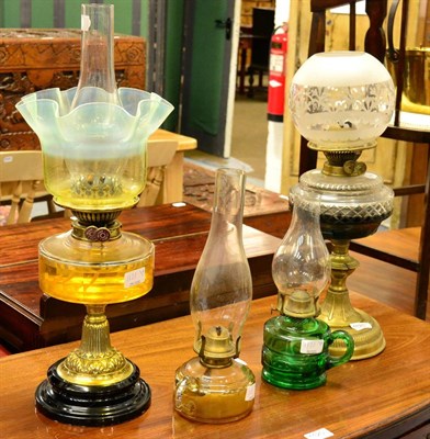 Lot 1121 - Two Victorian brass oil lamps, with glass shades and two others