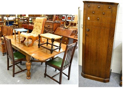 Lot 1138 - An oak drawer leaf table, four dining chairs, a single drawer wardrobe, two stools and a small...