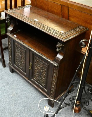 Lot 1139 - A carved oak small side cupboard, the top with Greek key border