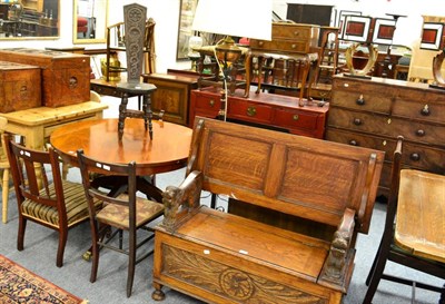 Lot 1140 - An carved oak monks bench with hinged top and seat together with a spinning chair, standard lamp, a