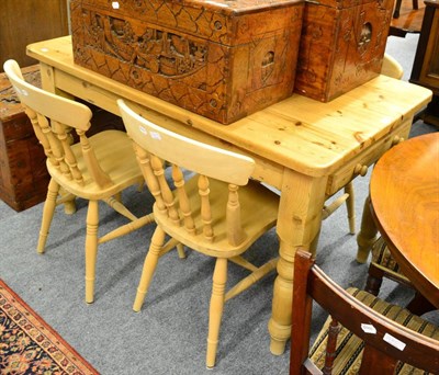 Lot 1141 - A pine table and chairs