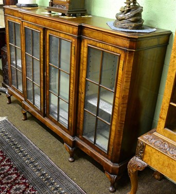 Lot 1210 - An early 20th century Queen Anne style walnut breakfront bookcase