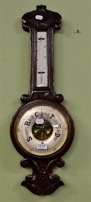 Lot 1214 - A carved oak wheel barometer and thermometer