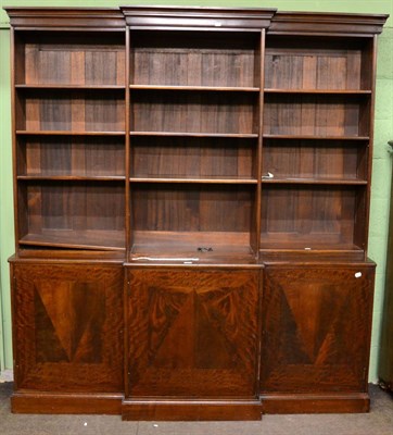 Lot 1216 - A reproduction mahogany break front bookcase