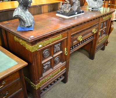 Lot 1244 - An Arts & Crafts oak sideboard, stamped 'Thos. Turner Manchester', heavily carved detail, brass...