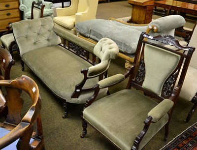 Lot 1287 - A late Victorian part salon suite comprising a sofa/chaise and a pair of open armchairs