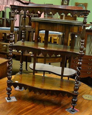 Lot 1295 - Mahogany three tier serpentine standing shelves with turner supports